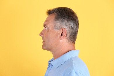 Photo of Mature man on color background. Hearing problem