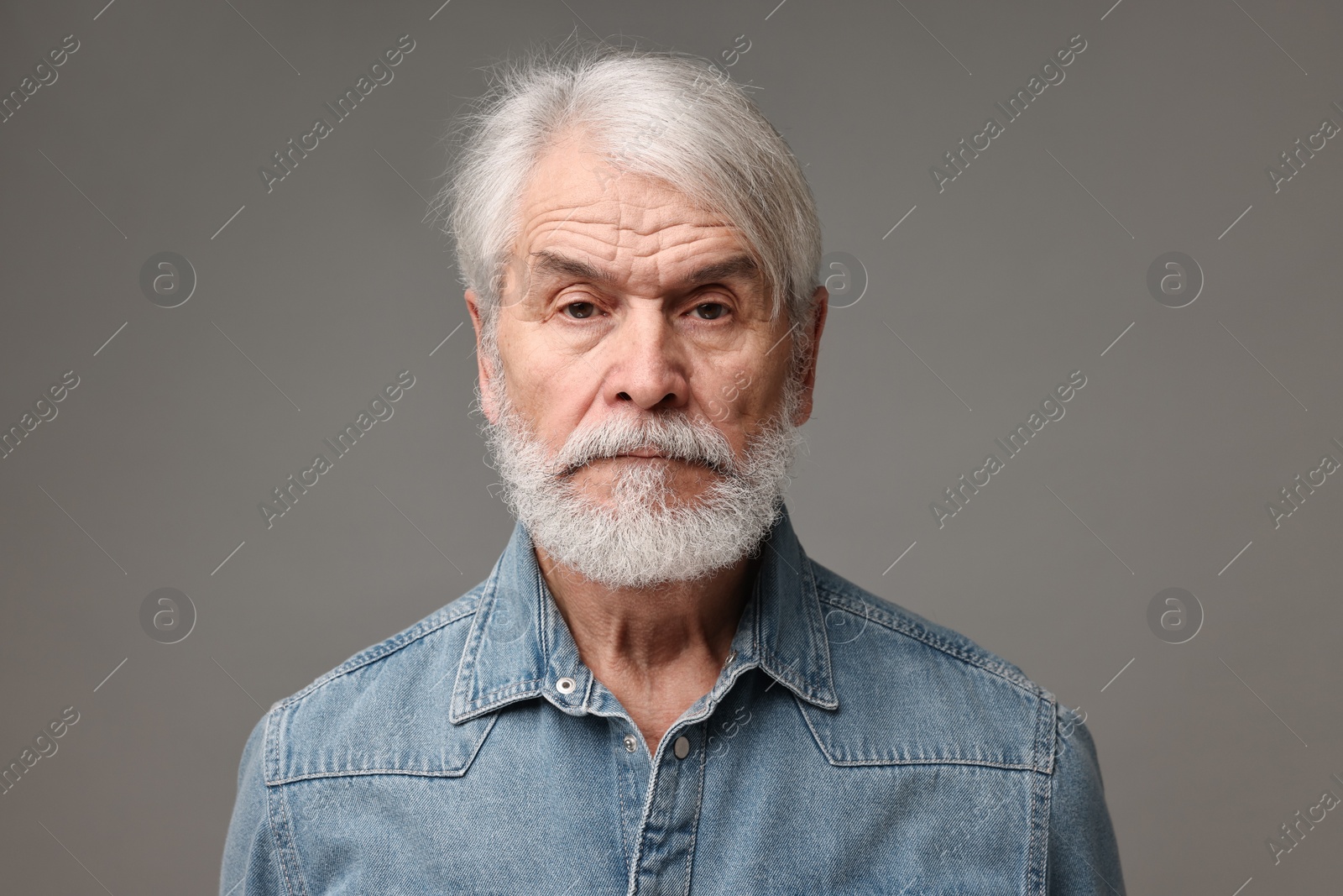 Photo of Senior man with mustache on grey background