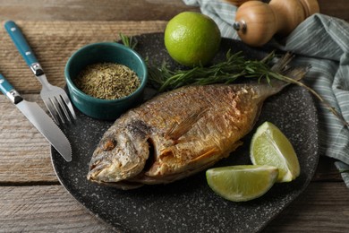 Photo of Delicious dorado fish served on wooden table