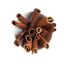 Photo of Cinnamon sticks in bowl isolated on white, top view