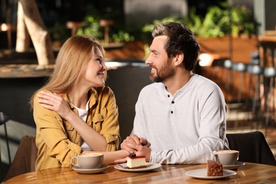 Photo of Romantic date. Happy couple spending time together in cafe