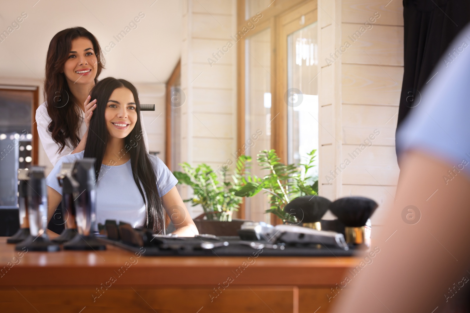 Photo of Hairdresser working with client in beauty salon