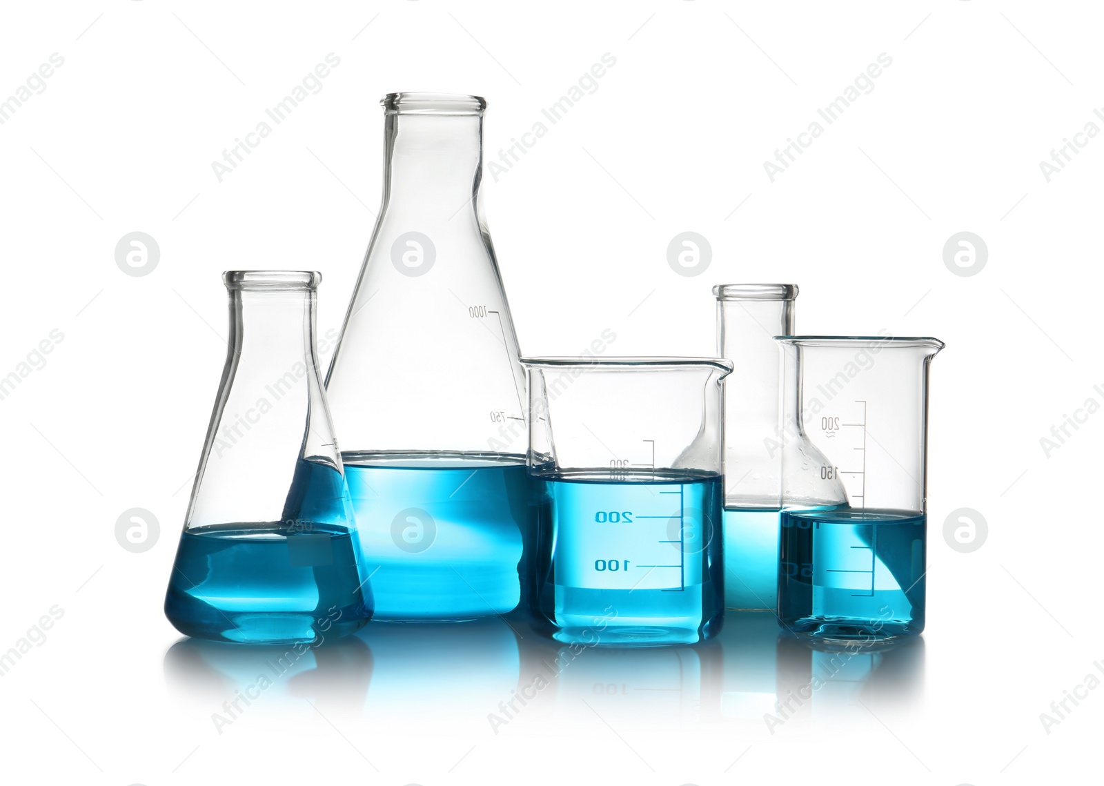 Photo of Laboratory glassware with liquid on table against white background. Chemical analysis