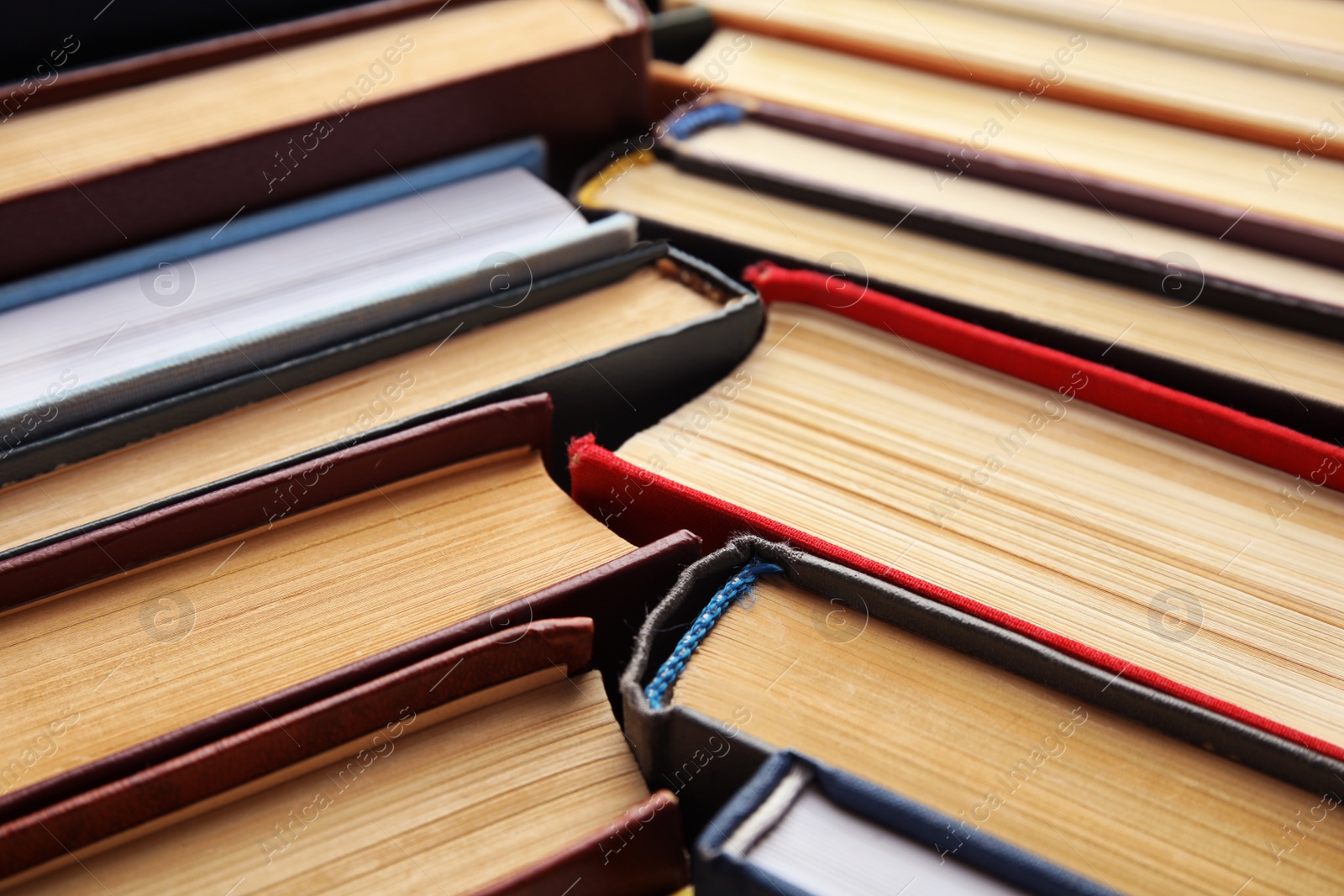 Photo of Many different hardcover books as background, closeup