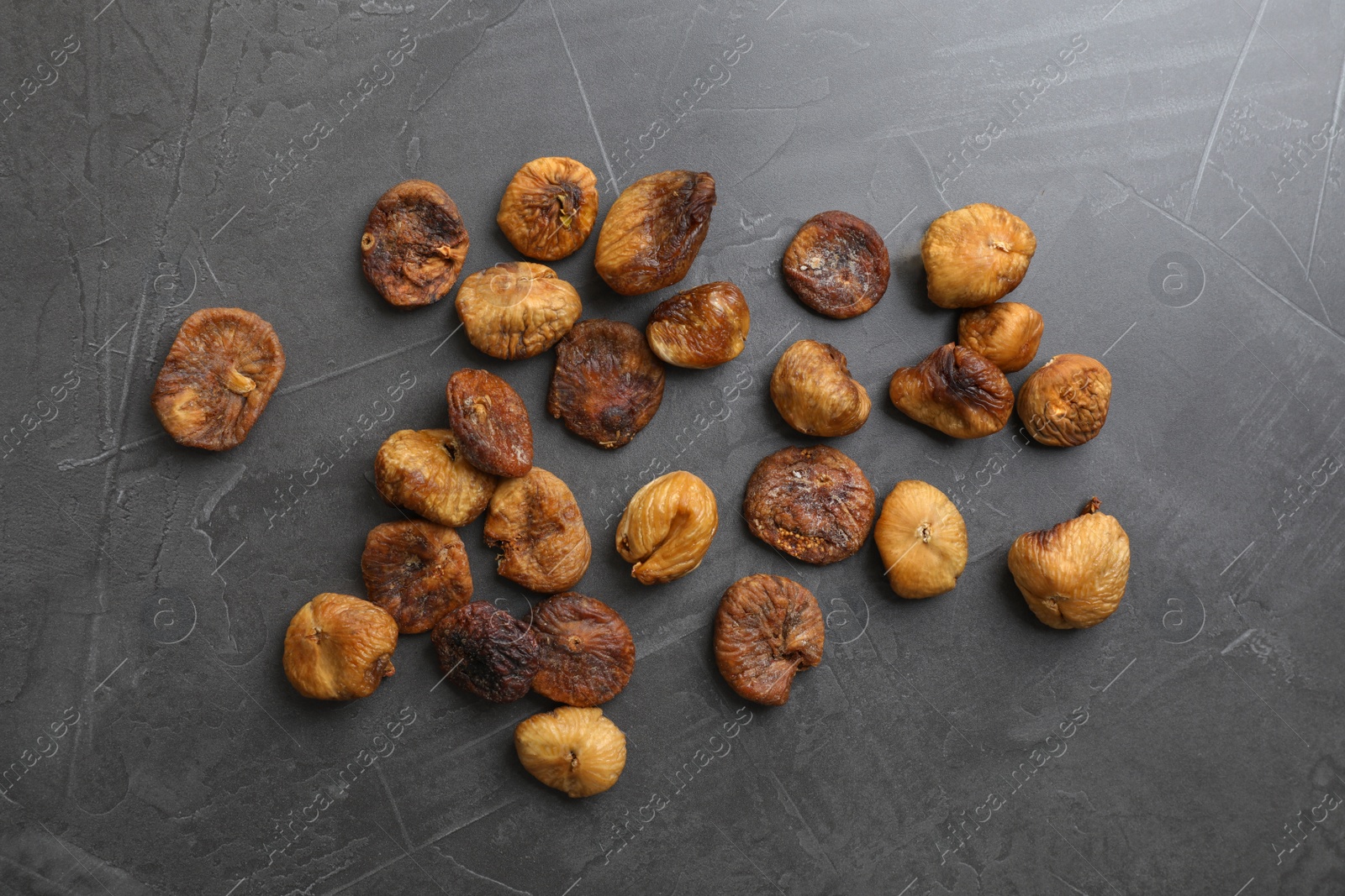 Photo of delicious dried figs on grey background, top view. Organic snack
