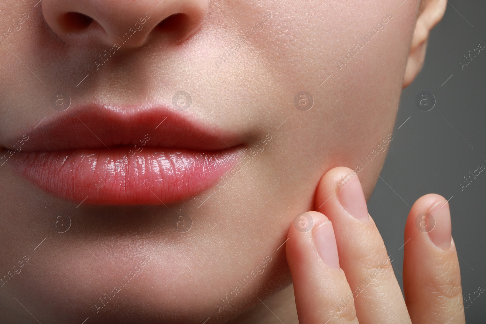 Photo of Closeup view of woman with healthy skin on light grey background