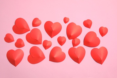 Photo of Small paper hearts on color background, top view