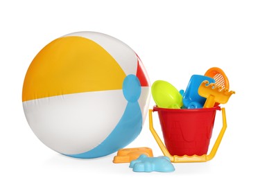 Photo of Inflatable colorful beach ball and child plastic toys on white background