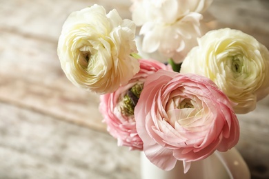 Photo of Vase with beautiful ranunculus flowers on table, closeup