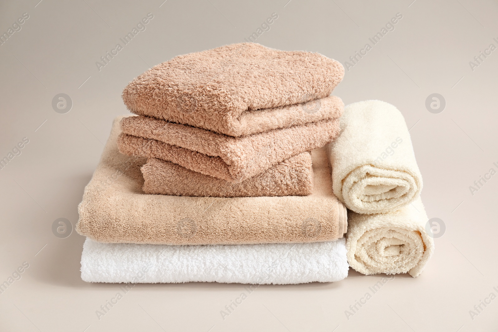 Photo of Soft bath towels on grey background