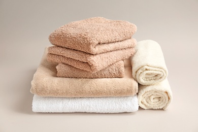 Photo of Soft bath towels on grey background