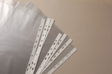 Punched pockets on light grey background, flat lay. Space for text