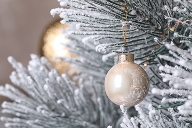 Beautiful Christmas tree with festive decor on brown background, closeup