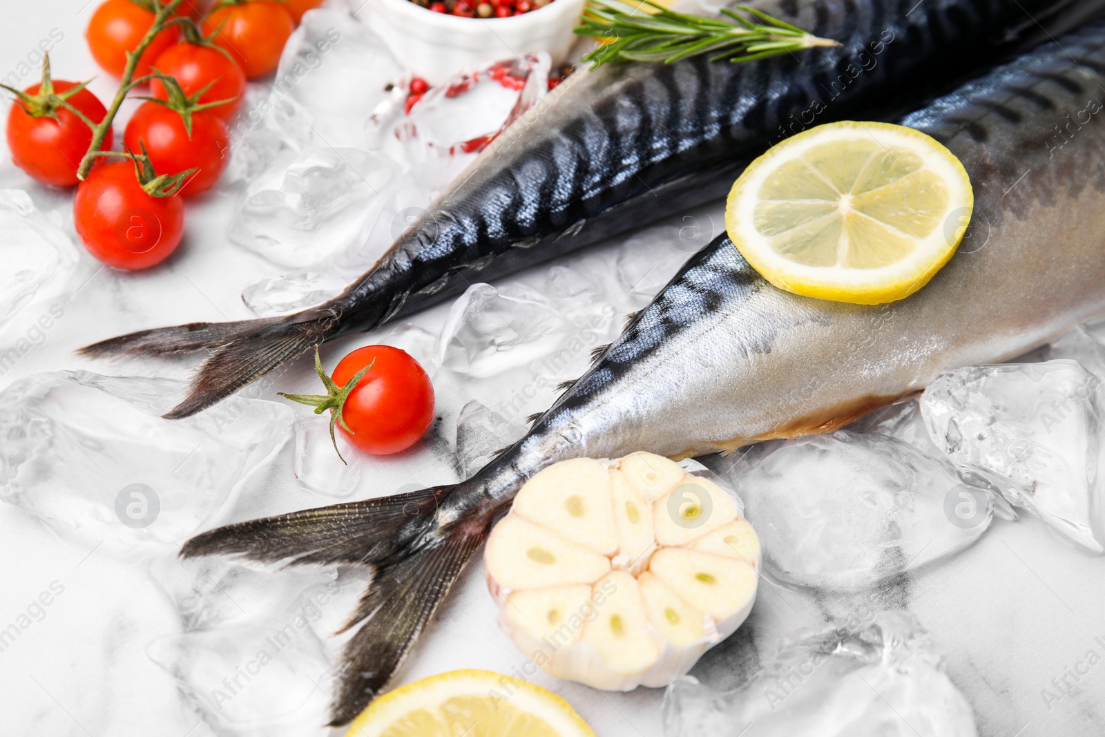 Photo of Tasty raw mackerel and ingredients on white marble table, closeup