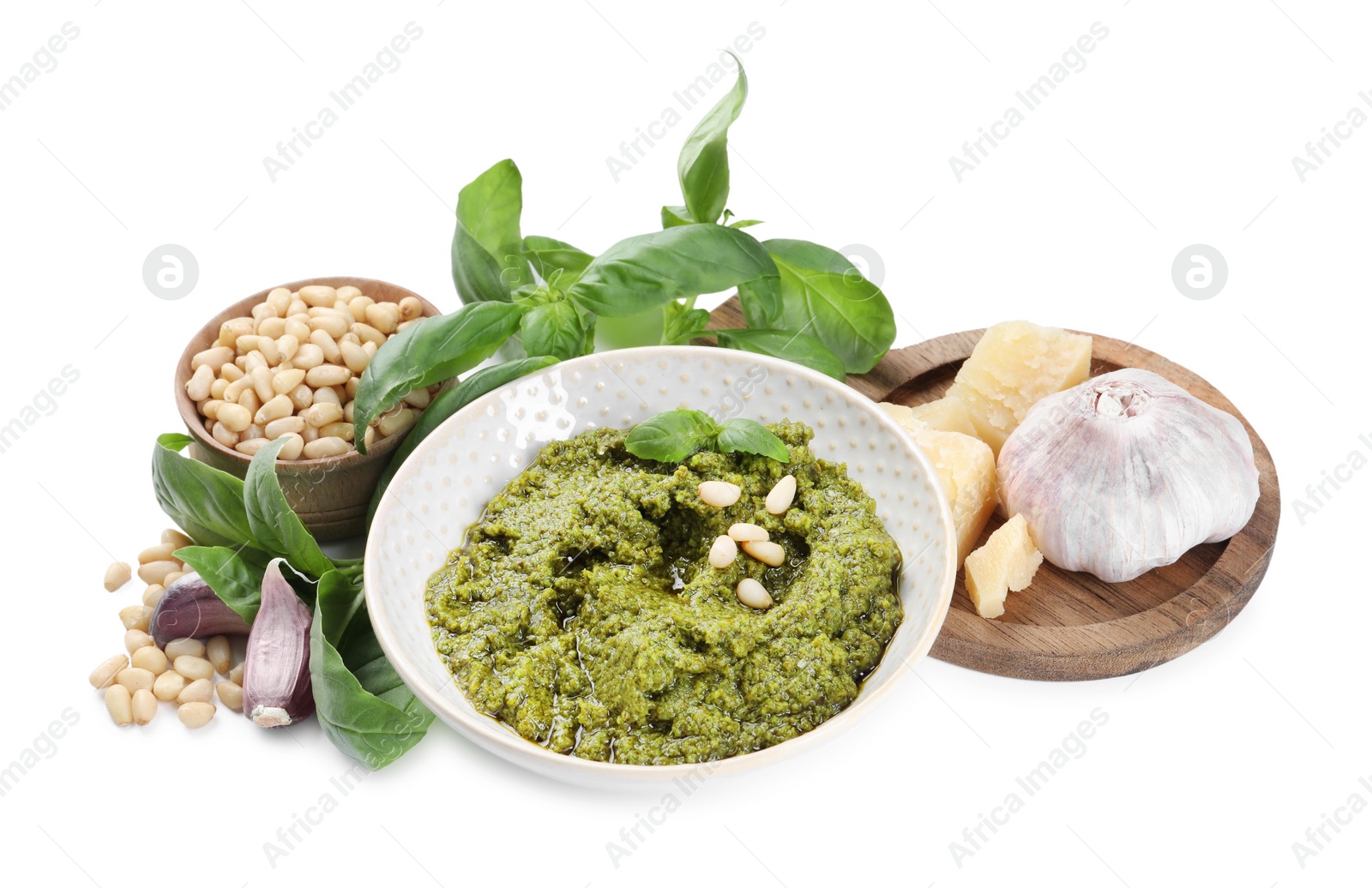 Photo of Fresh tasty pesto sauce and ingredients isolated on white