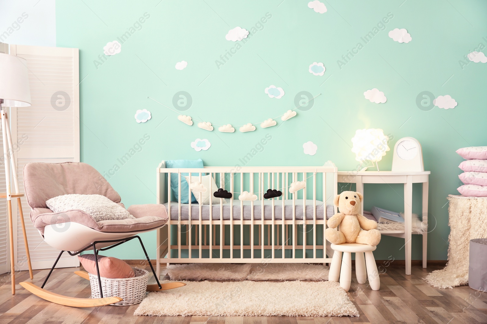 Photo of Modern baby room interior with crib and rocking chair