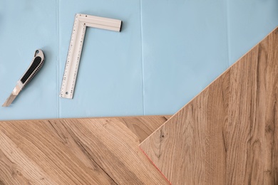 Installation of laminated wooden floor at home, top view