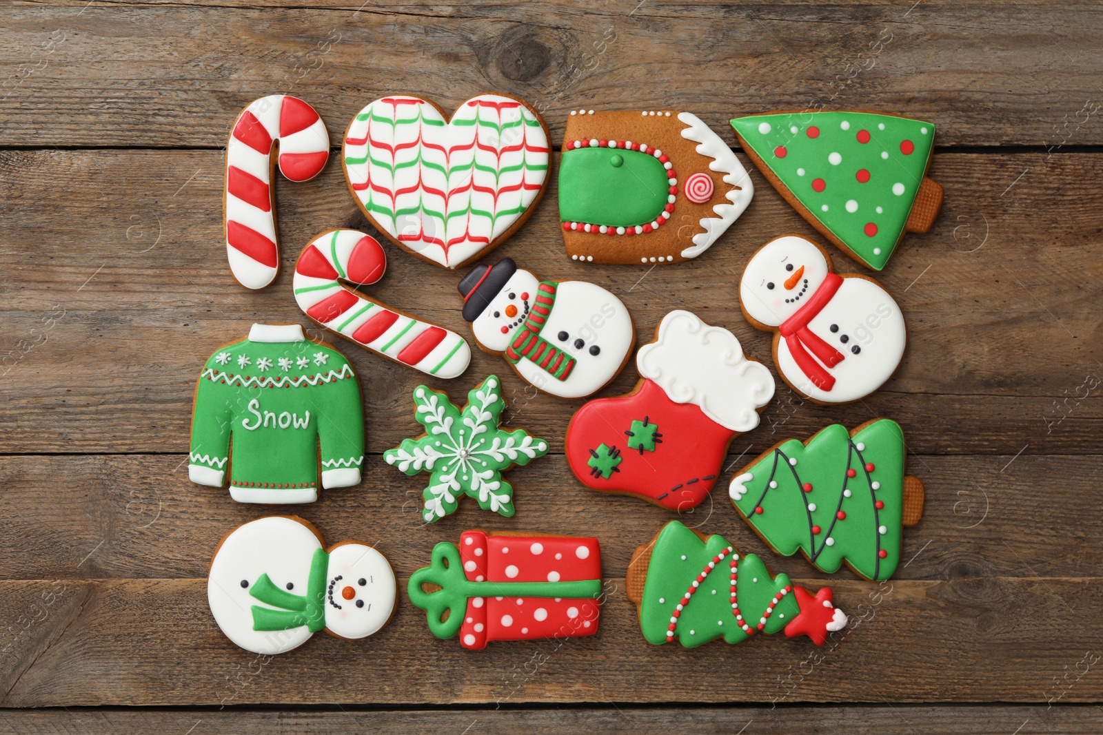 Photo of Many different delicious Christmas cookies on wooden table, flat lay