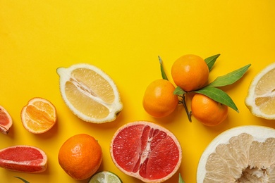 Photo of Different citrus fruits on color background, top view. Space for text