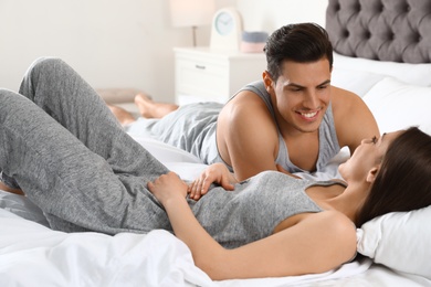 Photo of Portrait of lovely young couple resting in large bed