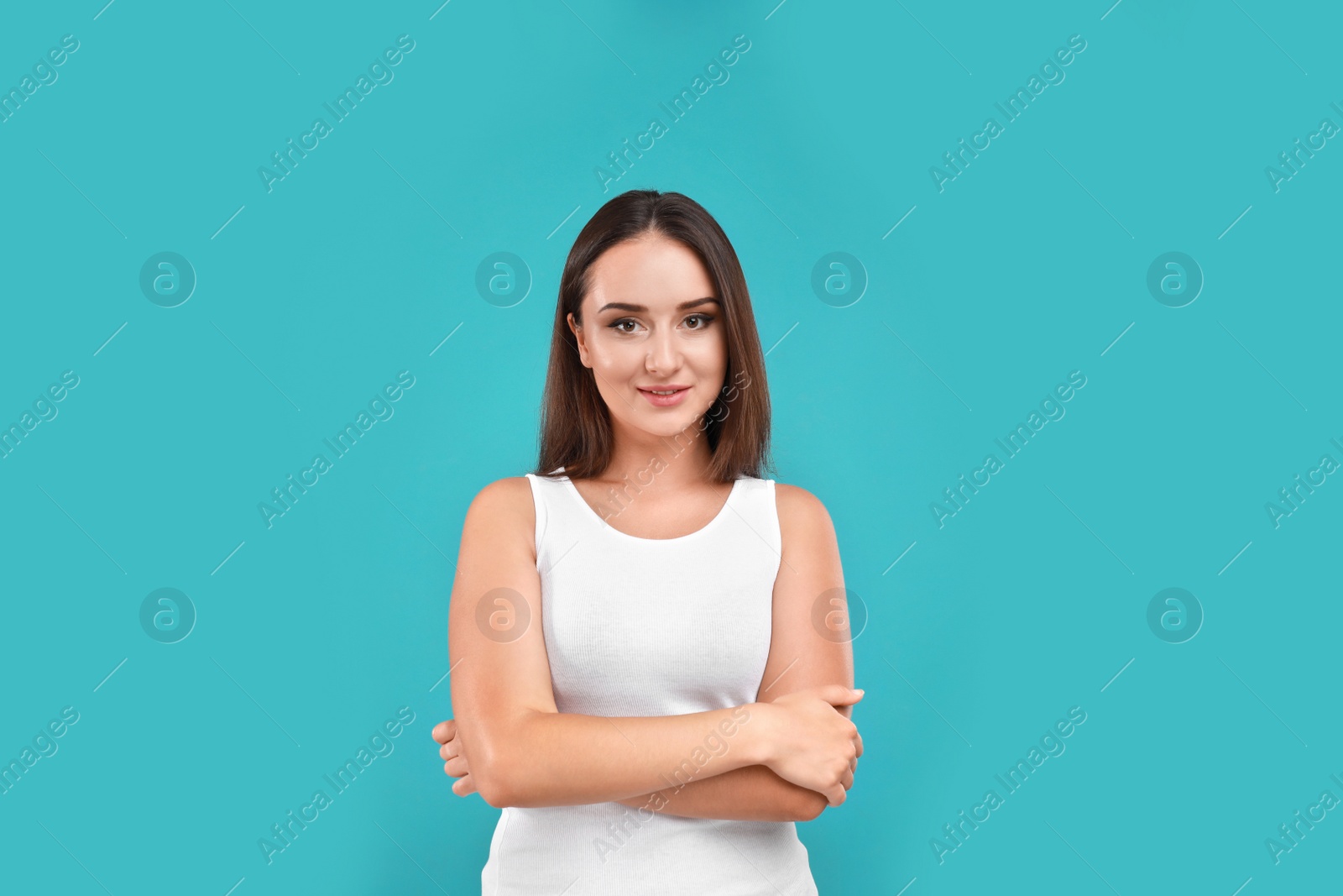 Photo of Beautiful young woman in casual outfit on turquoise background