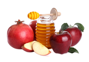 Photo of Honey, apples and pomegranates on white background. Jewish New Year (Rosh Hashanah) holiday