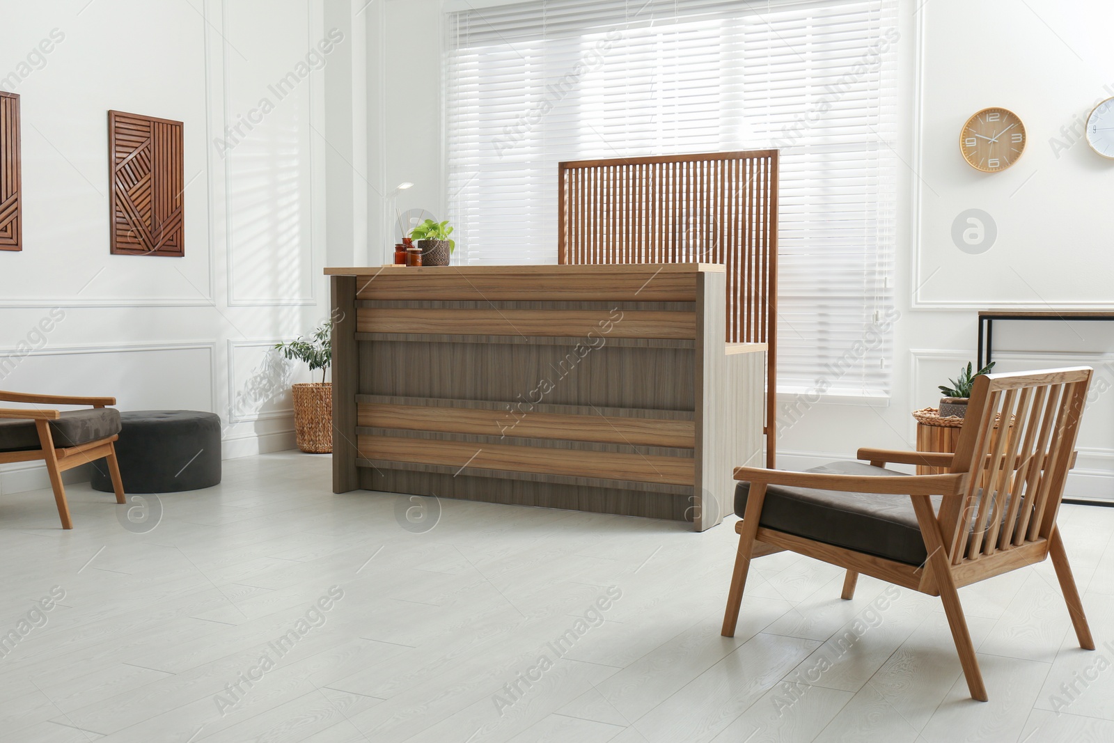 Photo of Stylish hotel lobby interior with wooden reception desk and armchairs