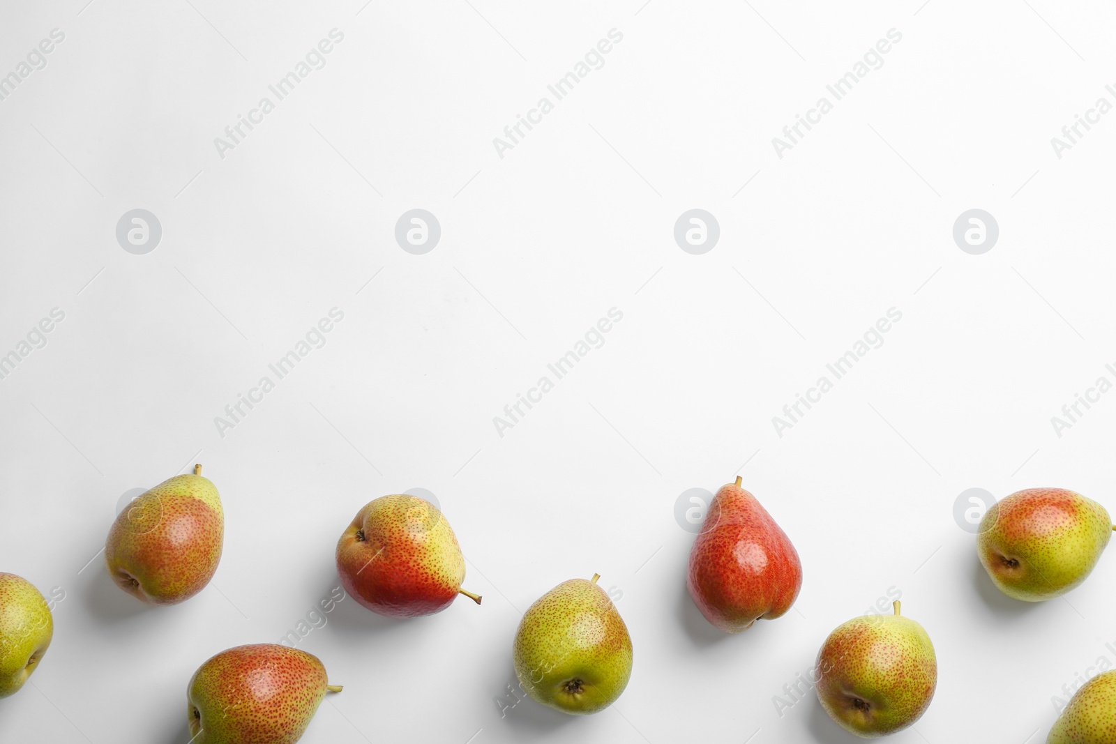 Photo of Ripe juicy pears on white background, top view