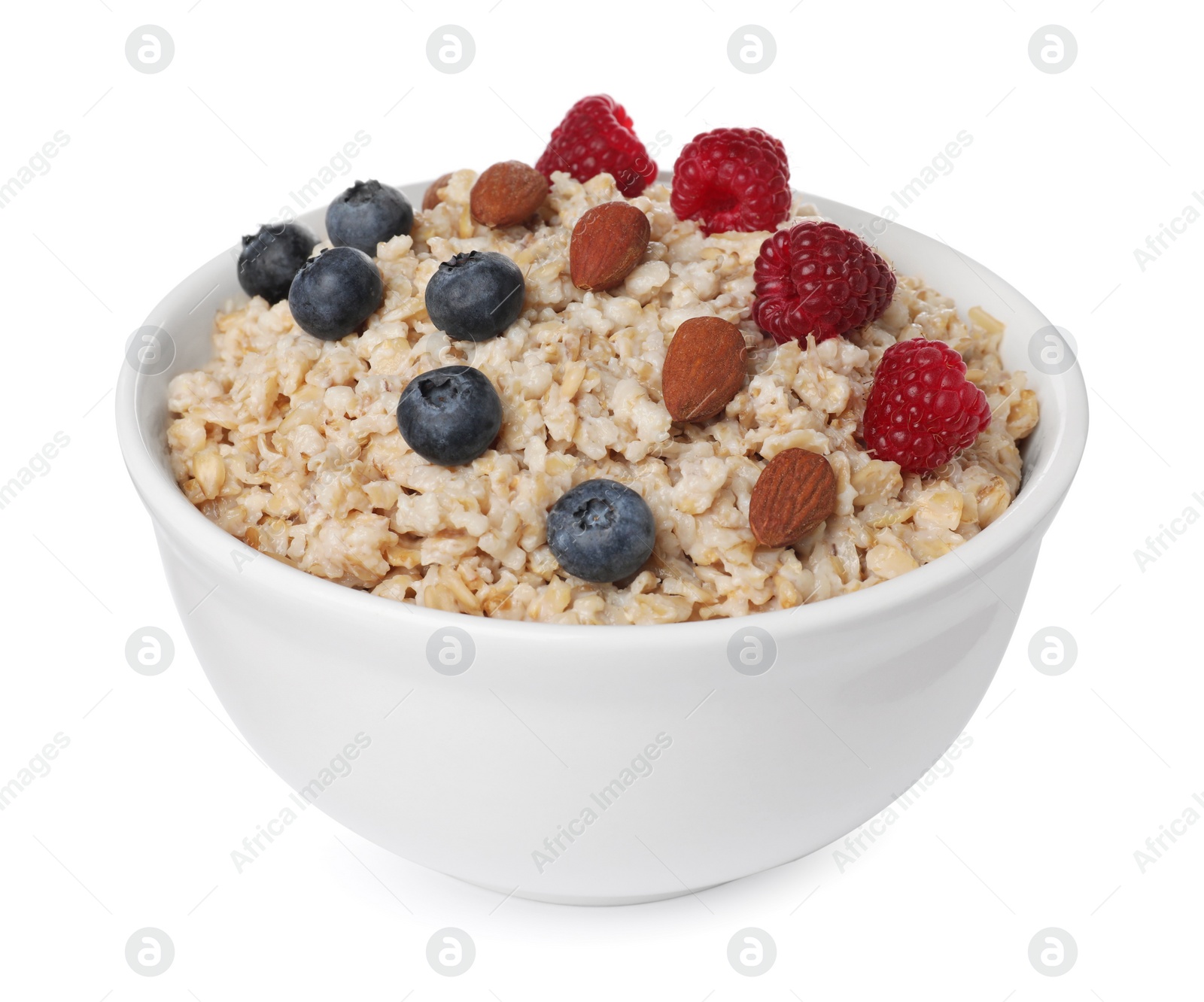 Photo of Tasty boiled oatmeal with berries and almonds in bowl isolated on white