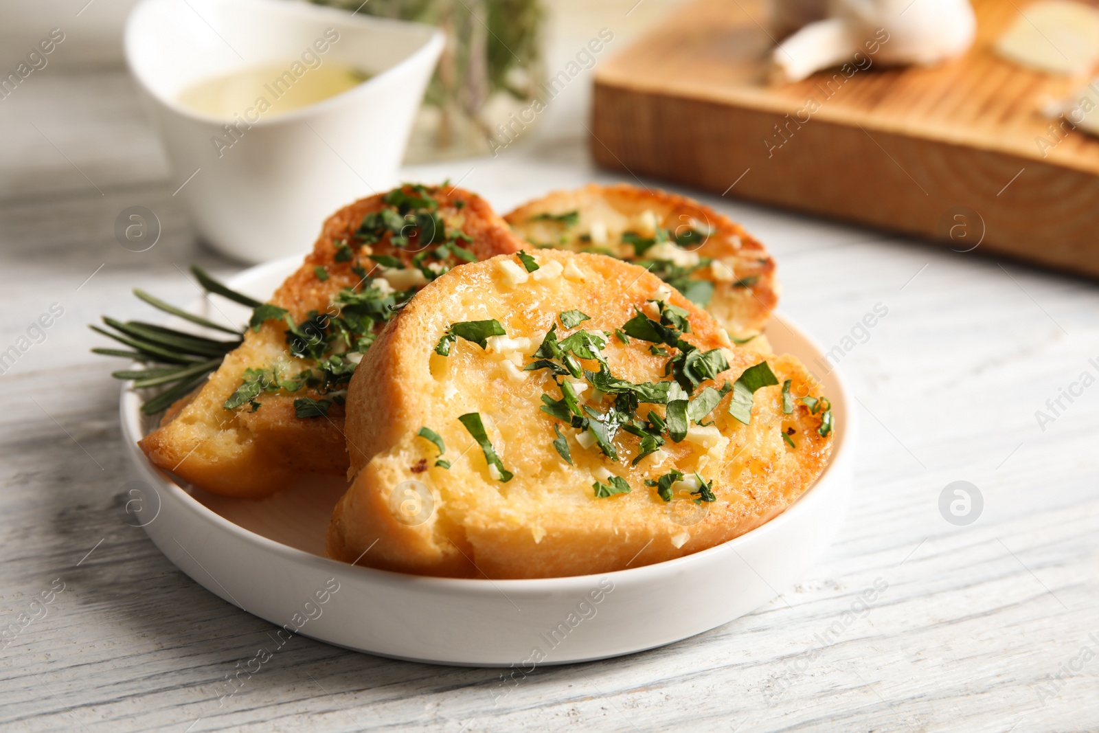 Photo of Plate with delicious homemade garlic bread on table. Space for text