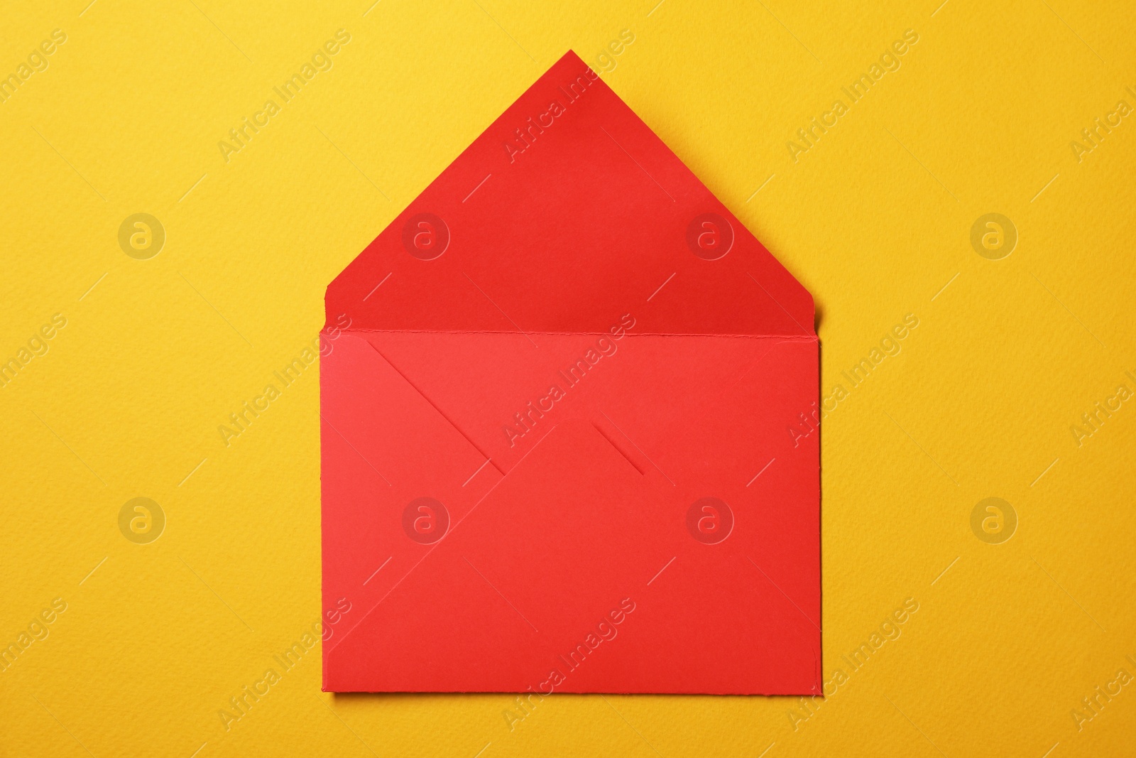 Photo of Red letter envelope on orange background, top view