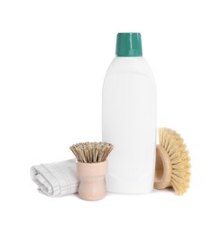 Photo of Bottle of cleaning product, rag and brushes isolated on white