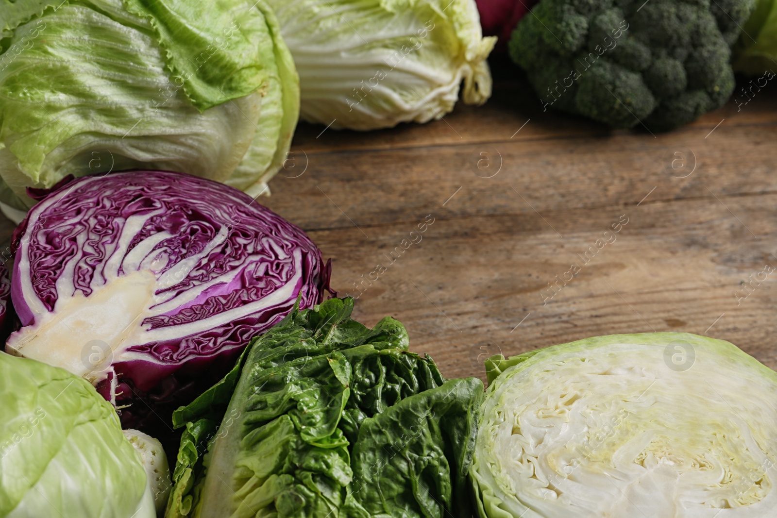 Photo of Different types of cabbage on wooden table