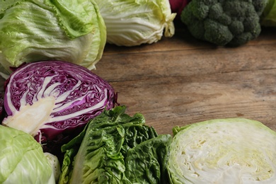 Photo of Different types of cabbage on wooden table