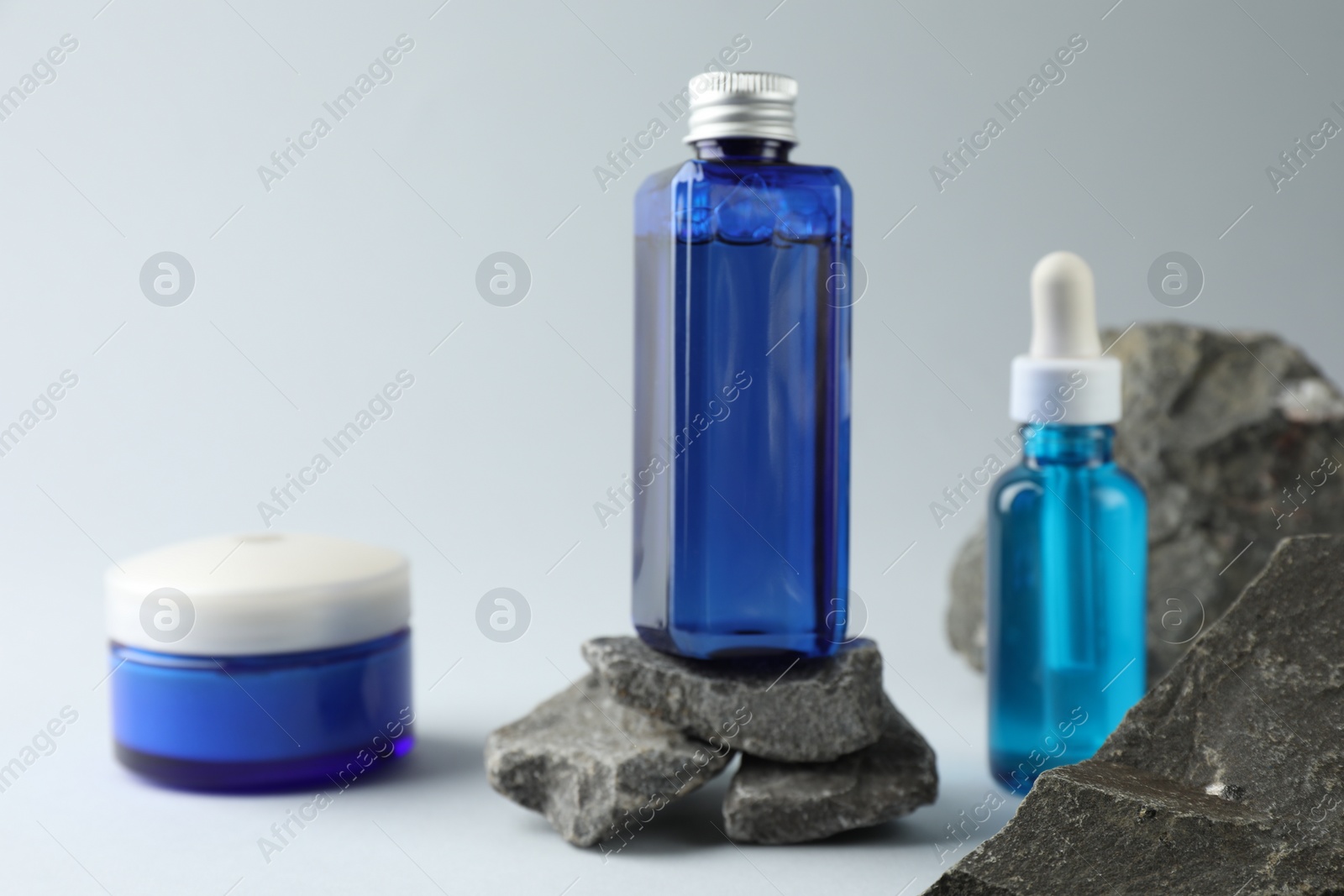 Photo of Set of cosmetic products on light grey background, closeup