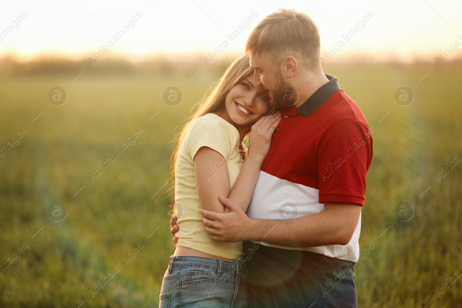 Photo of Happy young couple in green field on sunny spring day