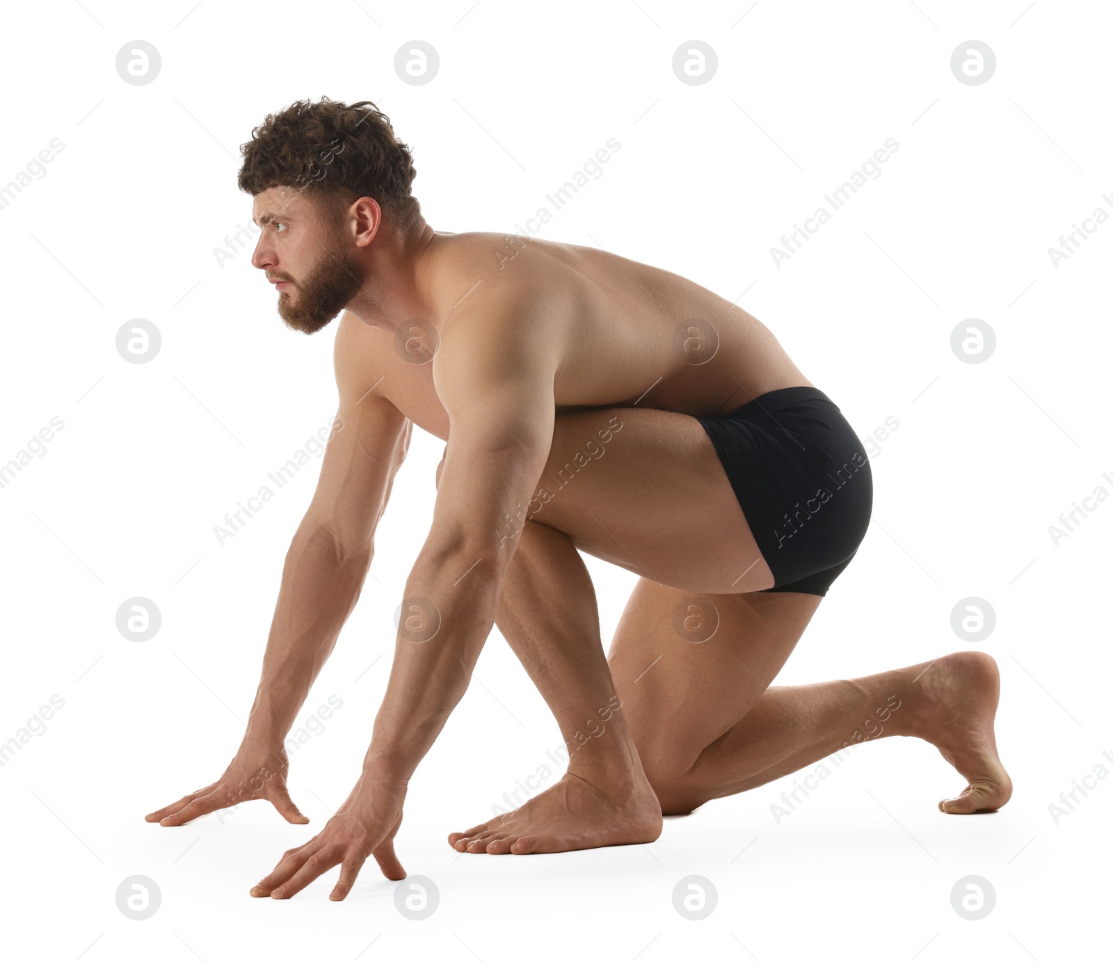 Photo of Handsome man in starting position for run on white background