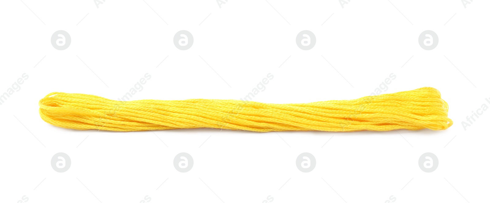 Photo of Bright yellow embroidery thread on white background