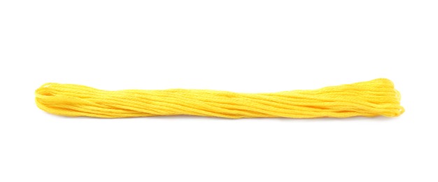 Photo of Bright yellow embroidery thread on white background