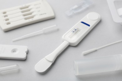 Photo of Disposable express test kits on light grey background, closeup