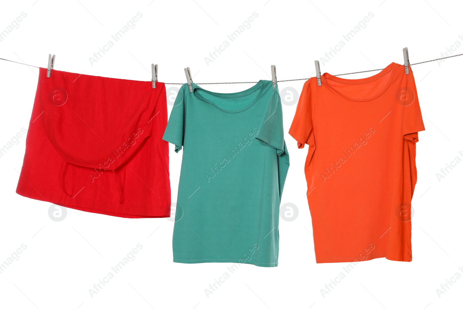 Photo of Different bright clothes drying on washing line against white background