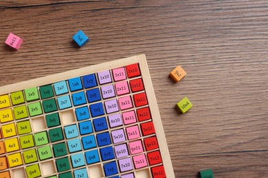 Photo of Colorful math game kit with arithmetical tasks on wooden table, flat lay