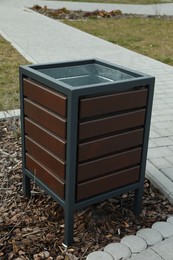 Photo of Trash bin in park on spring day