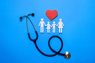 Photo of Paper family cutout, stethoscope and red heart on light blue background, flat lay. Insurance concept
