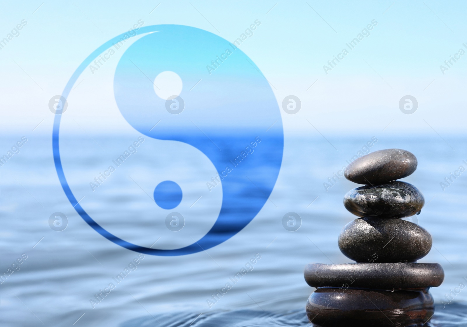 Image of Stack of stones in water and Ying Yang symbol. Feng Shui philosophy 