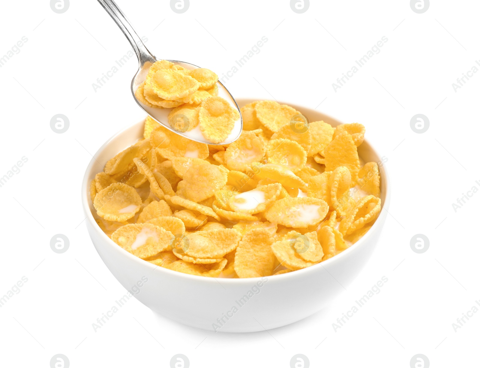 Photo of Spoon with corn flakes and milk over bowl on white background