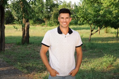 Handsome man in park on sunny day