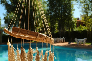 Photo of Hammock near pool with clean water outdoors, closeup