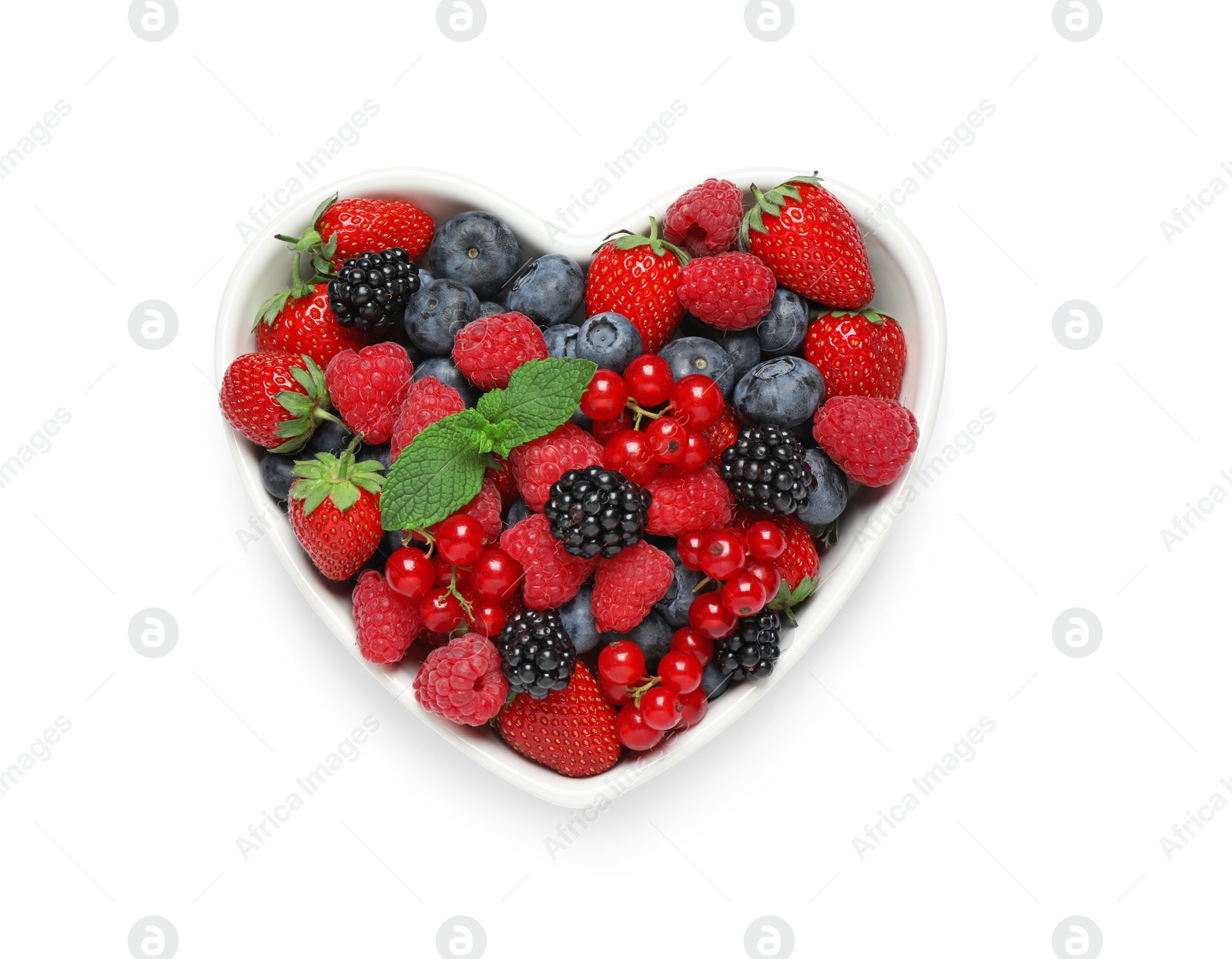 Photo of Mix of berries in heart shaped bowl isolated on white, top view