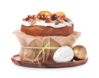Photo of Traditional Easter cake with dried fruits in parchment paper and painted eggs isolated on white